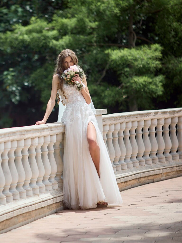 Bride wearing a lace wedding dress with a long veil and train