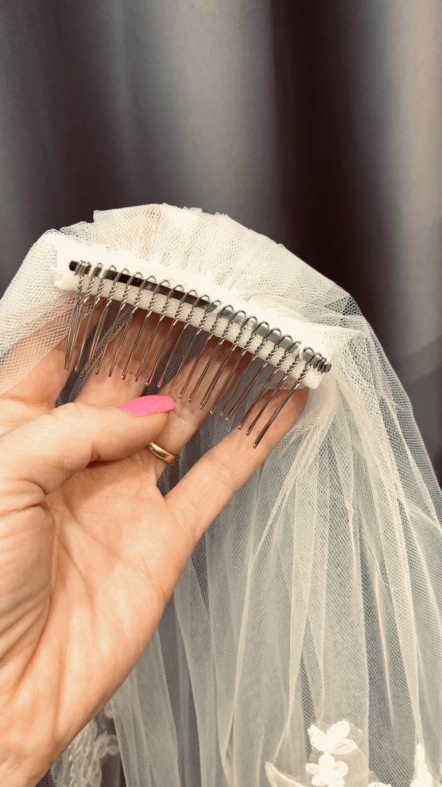 Close-up of a metal comb sewn securely to a bridal veil