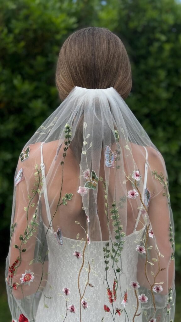 Back view of embroidered wildflower wedding veil with colorful flowers and butterflies