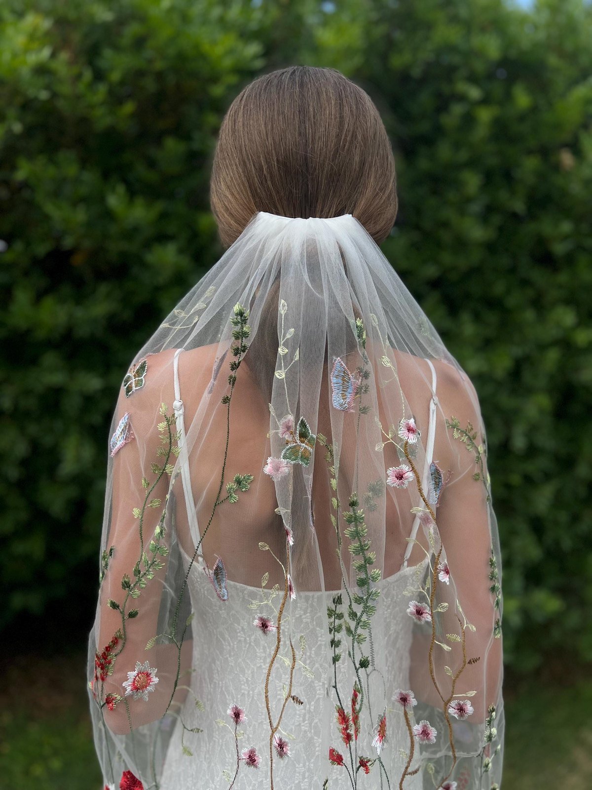 Back view of embroidered wildflower wedding veil with colorful flowers and butterflies