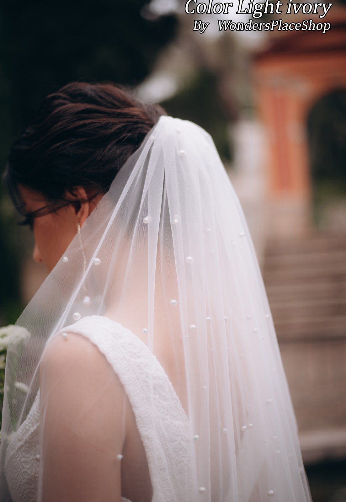 Close view of scattered pearl embellishments on a single-layer bridal veil