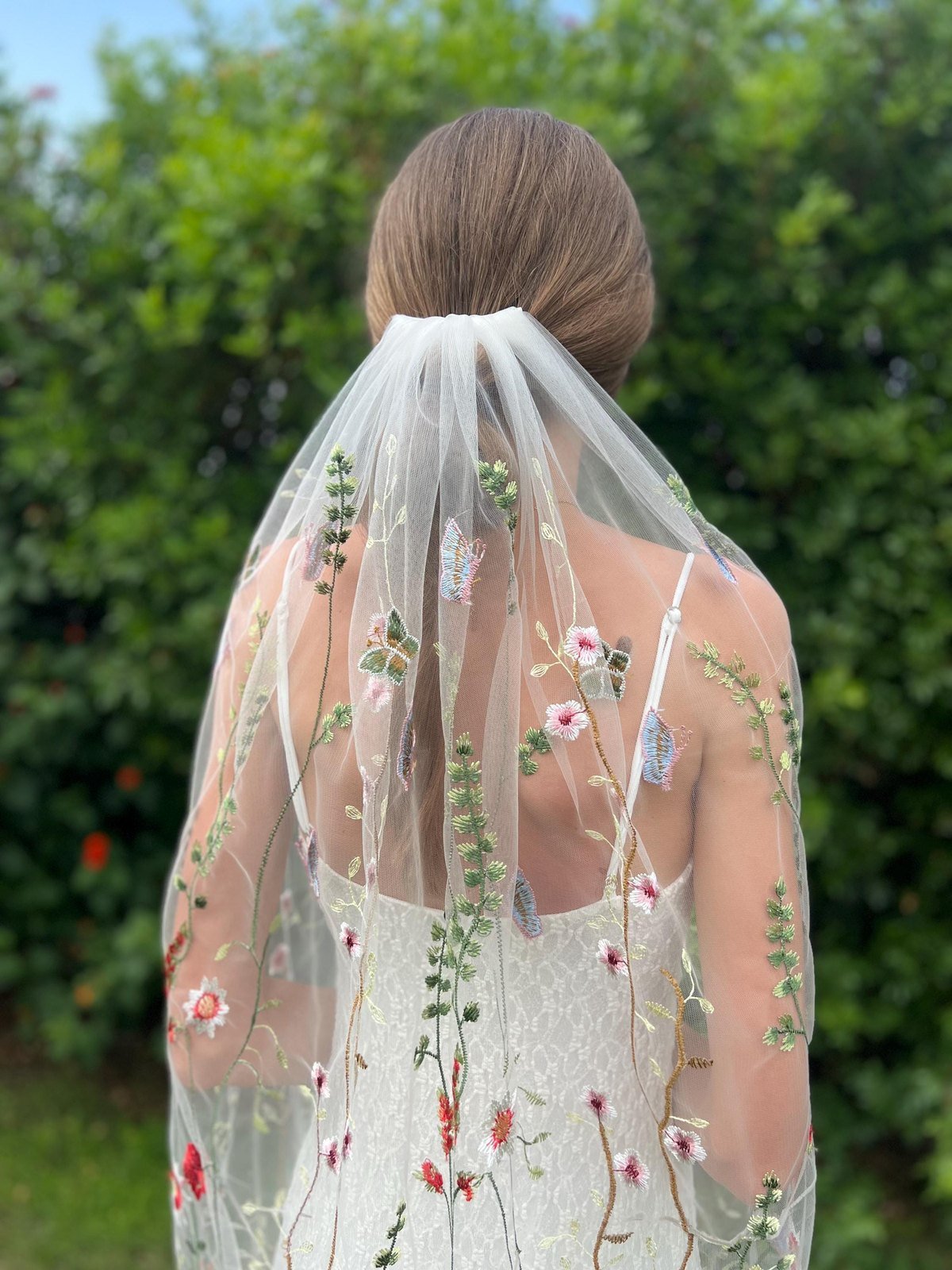 Colorful wildflower and butterfly embroidery on a soft tulle bridal veil
